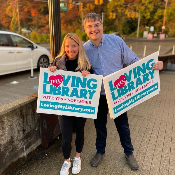 Campaign supporters holding Loving My Library signs